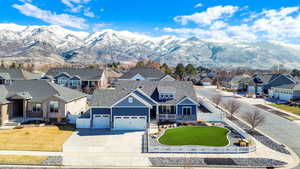 View of front of property featuring a residential view, an attached garage, fence, and a front lawn