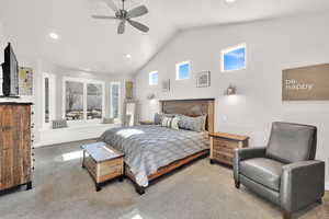 Carpeted bedroom with vaulted ceiling, a ceiling fan, and recessed lighting