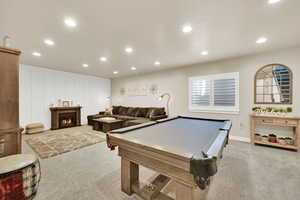 Playroom with recessed lighting, carpet floors, pool table, visible vents, and a lit fireplace