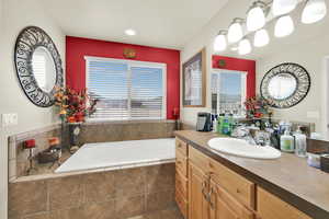 Bathroom with vanity and a bath