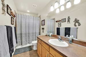 Full bathroom featuring visible vents, vanity, toilet, and tile patterned floors