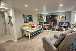 Sitting room featuring baseboards, carpet, tile patterned flooring, and recessed lighting