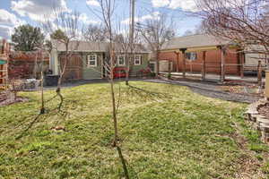 View of yard featuring fence and an outdoor structure