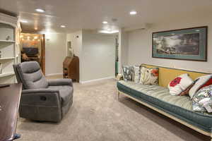 Living area featuring carpet floors, recessed lighting, and baseboards