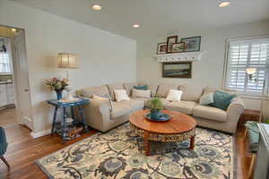 Living area with baseboards, wood finished floors, and recessed lighting