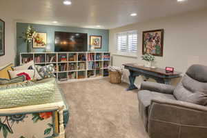 Living area featuring carpet flooring and recessed lighting