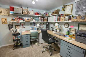 Office area featuring carpet floors and baseboards