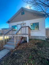 Rear view of property featuring fence