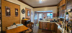 Kitchen featuring electric range, light countertops, and a sink