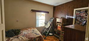 Bedroom with wood walls