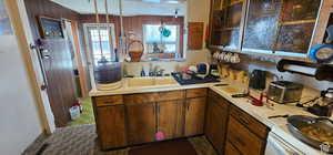 Kitchen with light countertops, a sink, and electric range