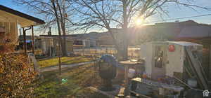 View of yard with fence and an outbuilding