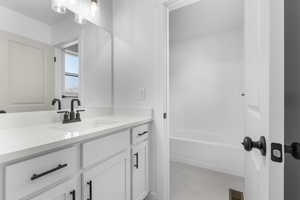 Bathroom with visible vents, vanity, and tile patterned floors