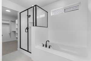Bathroom featuring a stall shower, a garden tub, a walk in closet, and tile patterned floors