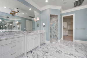 Bathroom with visible vents, baseboards, marble finish floor, ornamental molding, and a marble finish shower