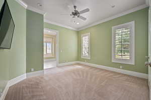 Unfurnished room featuring baseboards, carpet floors, and crown molding