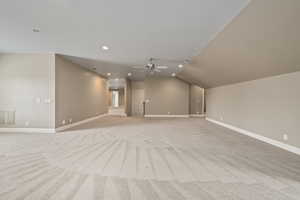 Interior space with baseboards, ceiling fan, recessed lighting, and light colored carpet