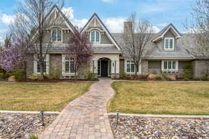 View of front of property featuring a chimney and a front lawn