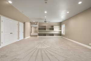 Unfurnished living room featuring recessed lighting, light colored carpet, and baseboards