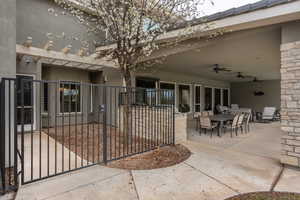 View of patio with ceiling fan and outdoor dining space