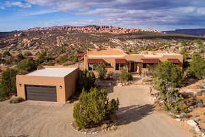 View of front facade featuring stucco siding, driveway, and a mountain view