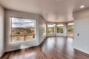 Unfurnished room with dark wood-style floors, recessed lighting, and baseboards