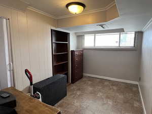 Office area featuring ornamental molding, visible vents, and baseboards