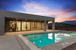 View of pool with a patio area and a pool with connected hot tub