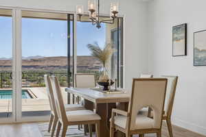 Dining room featuring a chandelier, wood finished floors, and a mountain view