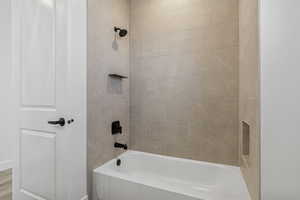 Bathroom featuring washtub / shower combination