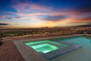 View of swimming pool with an in-ground hot tub, a mountain view, and a fenced backyard