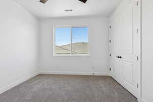 Unfurnished bedroom with carpet floors, a closet, and ceiling fan