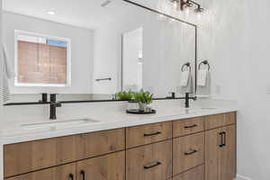 Bathroom with double vanity and recessed lighting