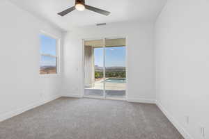 Spare room featuring carpet flooring and a ceiling fan