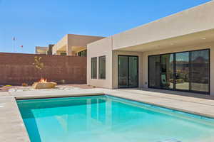 View of swimming pool featuring a patio and a fire pit
