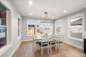 Dining area featuring recessed lighting, light wood-type flooring, visible vents, and baseboards