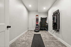 Workout area featuring carpet, baseboards, and recessed lighting