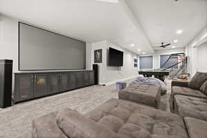 Carpeted home theater room with recessed lighting and baseboards