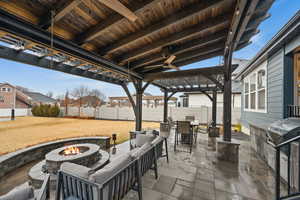 View of patio with area for grilling, an outdoor living space with a fire pit, a fenced backyard, outdoor dining area, and a pergola