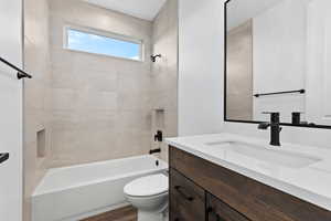 Full bathroom featuring vanity, shower / tub combination, and wood finished floors