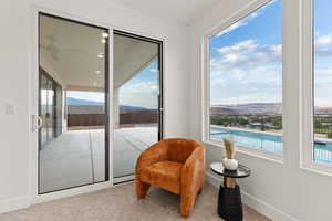 Sitting room featuring a mountain view and carpet flooring