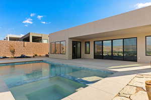 View of swimming pool featuring a patio area and a pool with connected hot tub