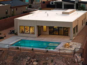 View of pool with an outdoor fire pit and a patio