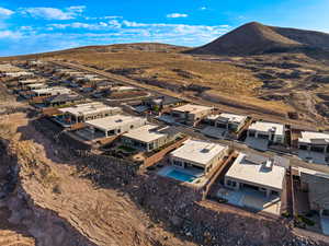 Aerial perspective of suburban area featuring mountains and a pool