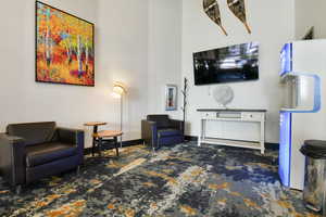 Living room with carpet floors and baseboards