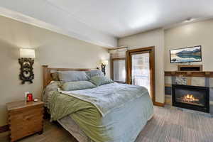 Bedroom featuring a fireplace and baseboards