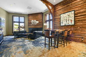 Dining area featuring carpet floors, a fireplace, and baseboards