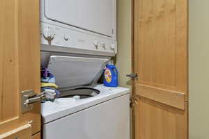 Laundry area featuring laundry area and stacked washer and clothes dryer