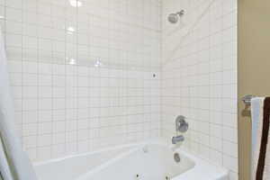 Bathroom with a combined bath / shower with jetted tub