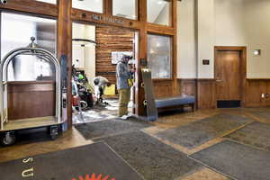 Workout area with a high ceiling and wainscoting